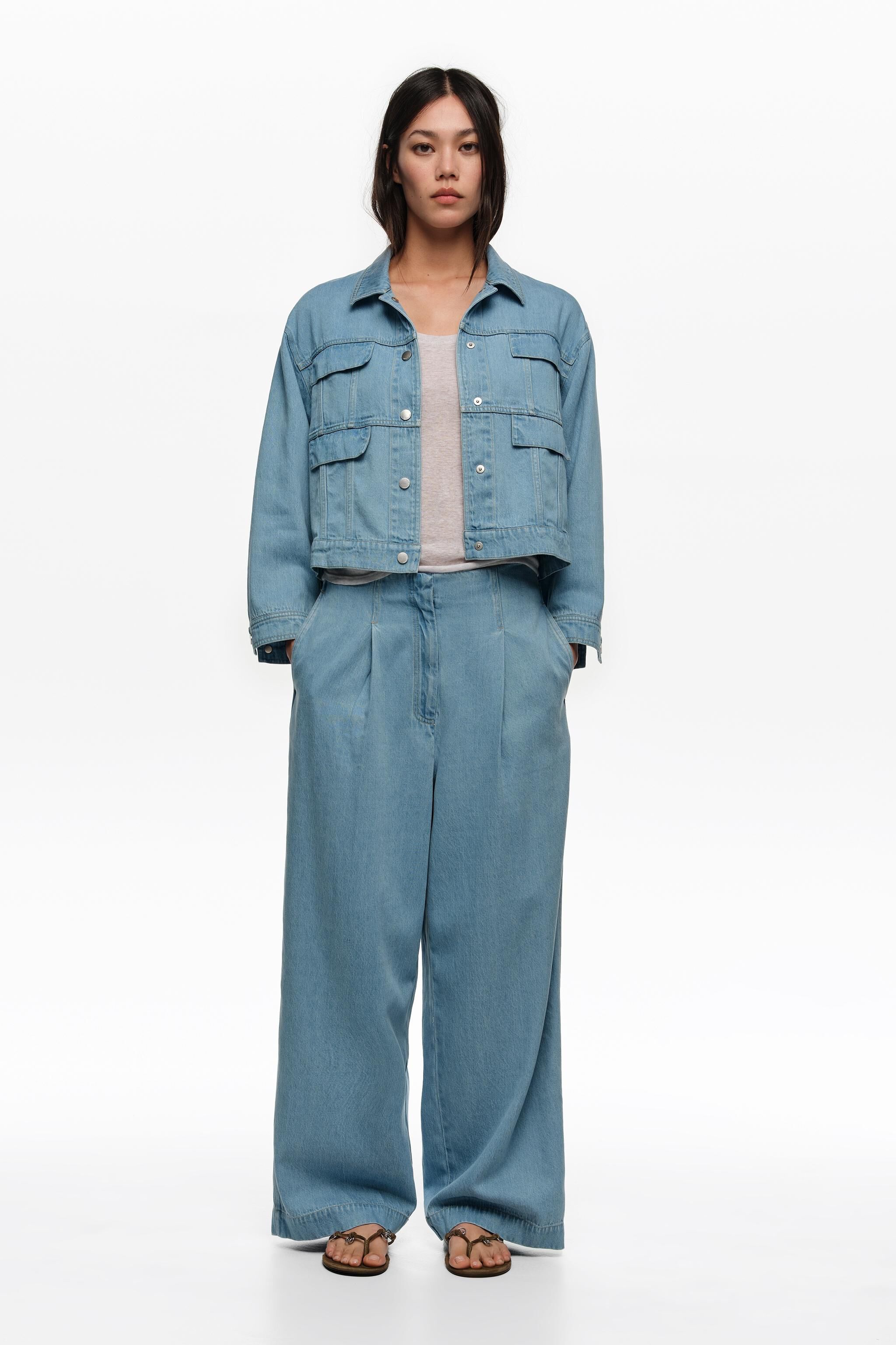 Helleblaue Fließdenim-gerade Hosen mit Falten